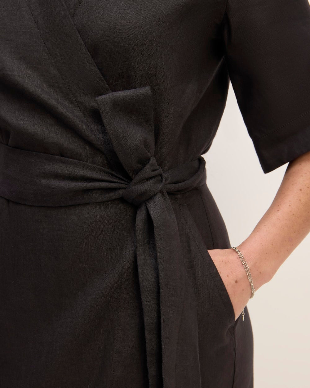 The Wrap Dress in Linen in Black — detail view