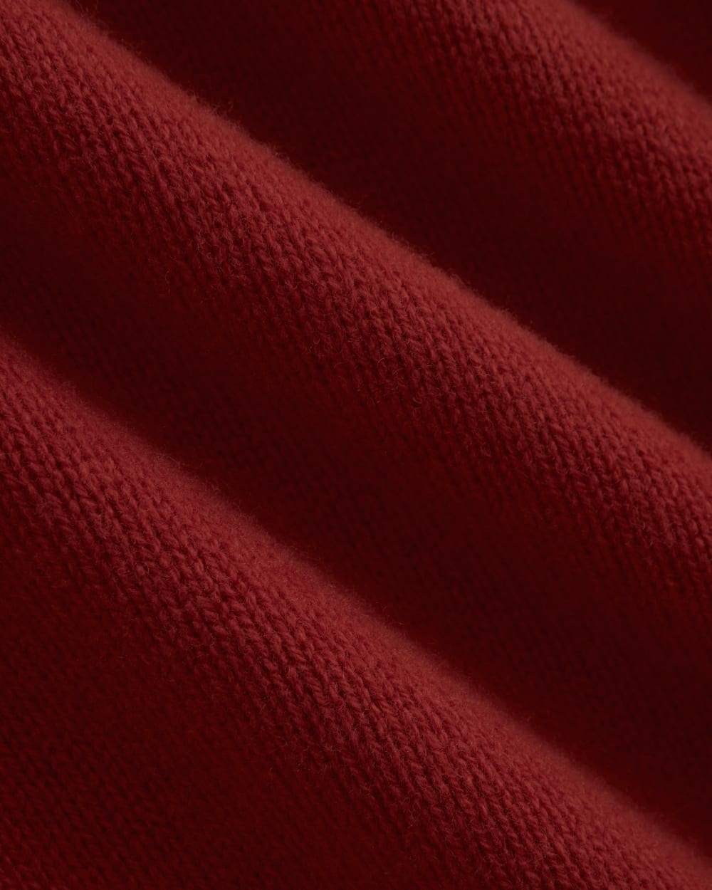 V-Neck Sweater in Extrafine Luxe Merino in Berry Red — detail view