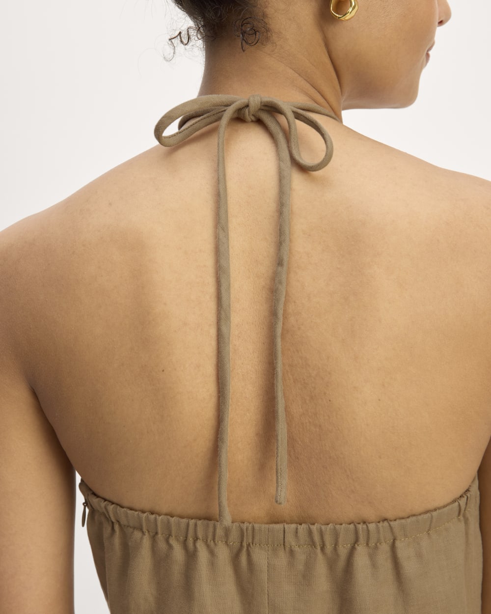 The Linen Halter-Neck Dress in Tiger's Eye — detail view