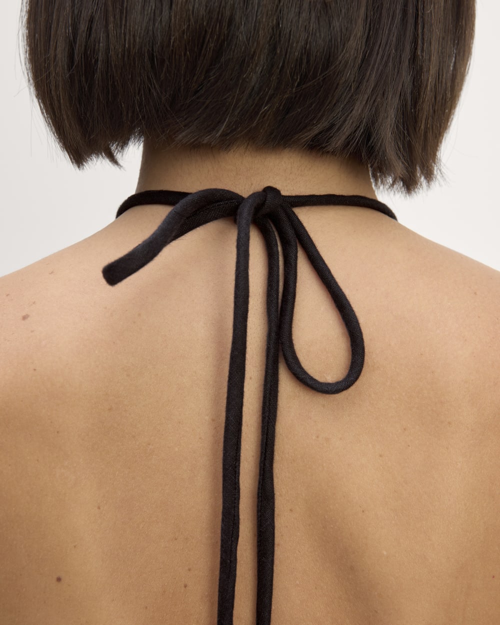 The Linen Halter-Neck Dress in Black — detail view