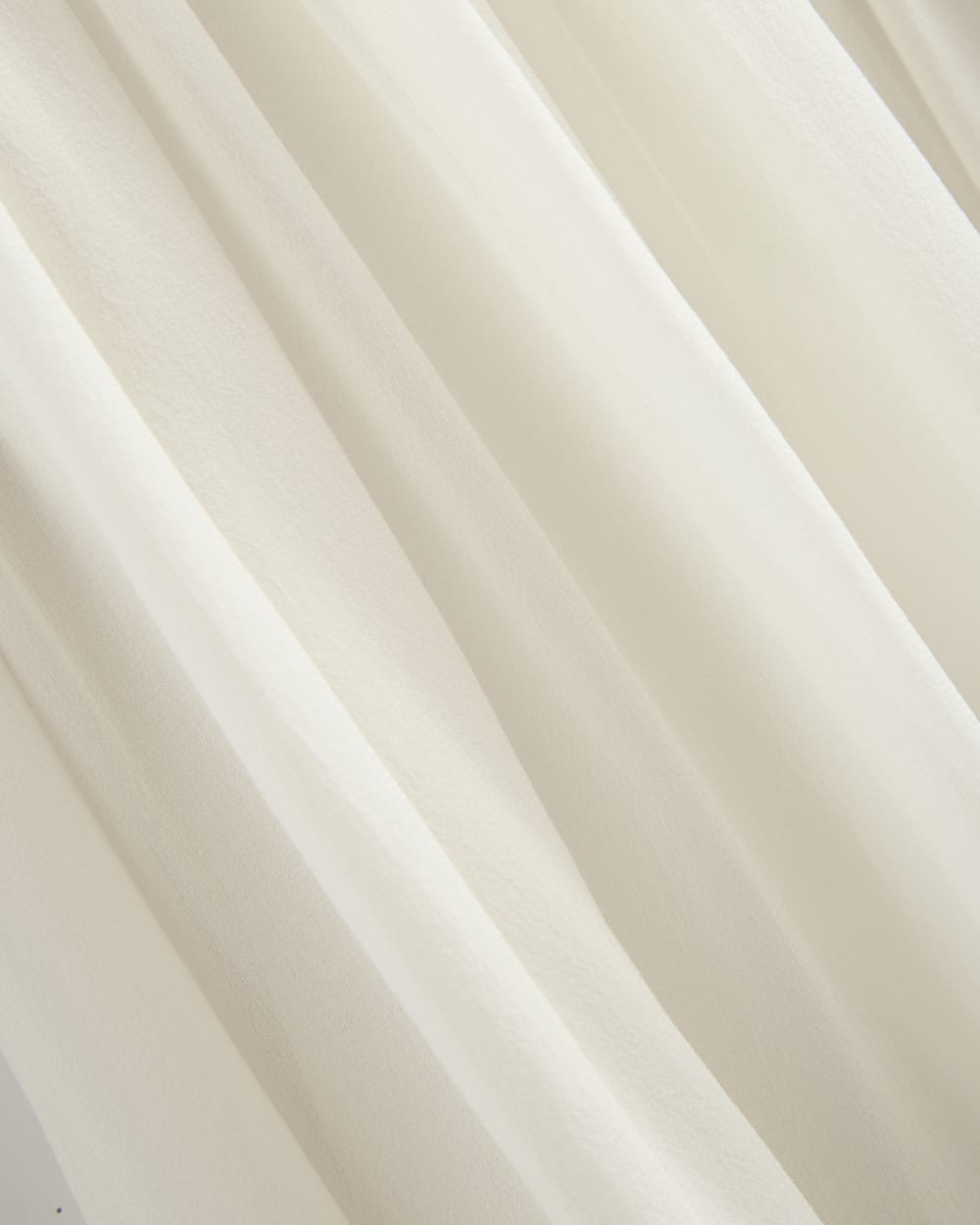 Twisted Pleated Mini Dress in Silk Georgette in Bone — detail view