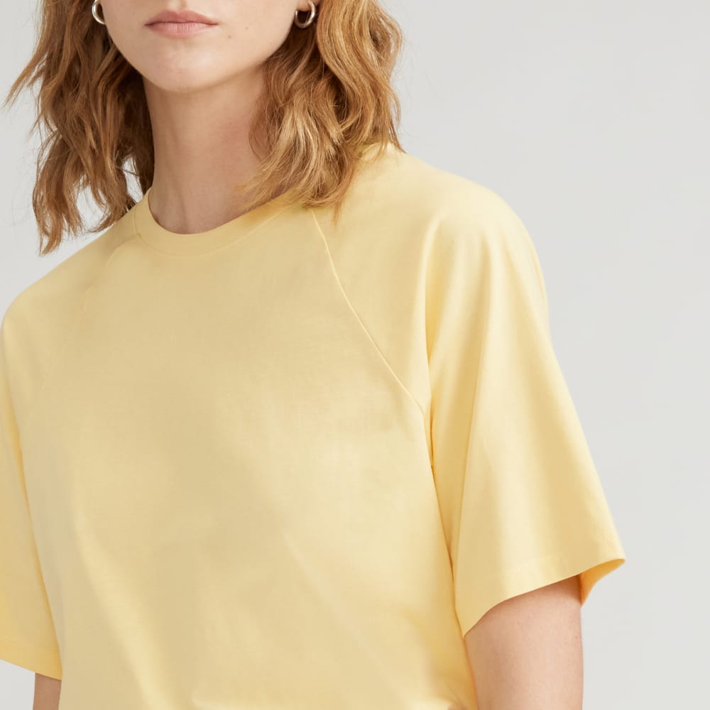 The Organic Cotton Raglan Tee in Pale Yellow — detail view