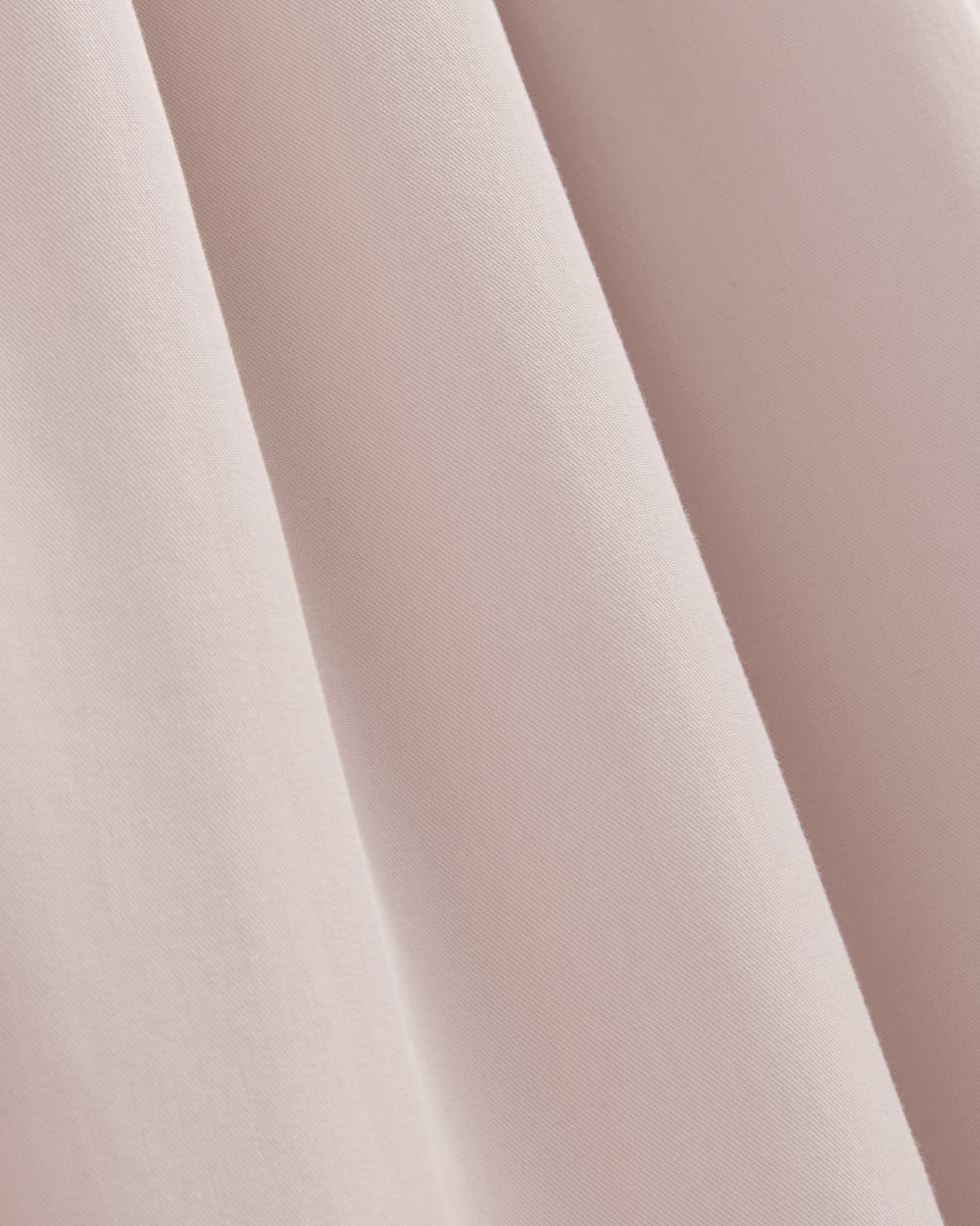 The Pleated Slip Dress in Butterlite in Soft Rose — detail view