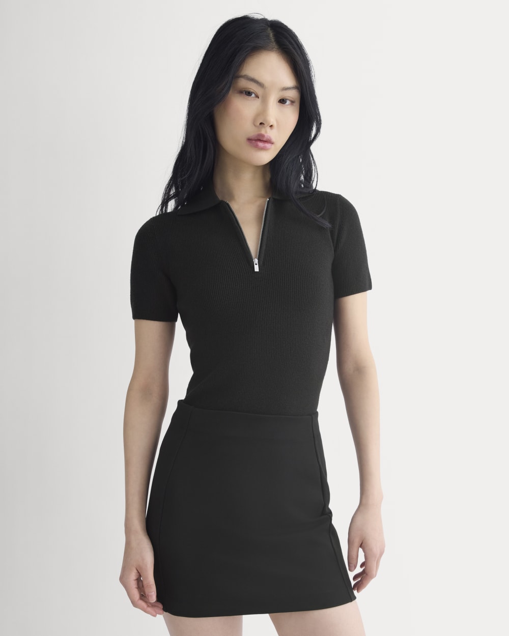 Knit Quarter-Zip Polo in Black — front view
