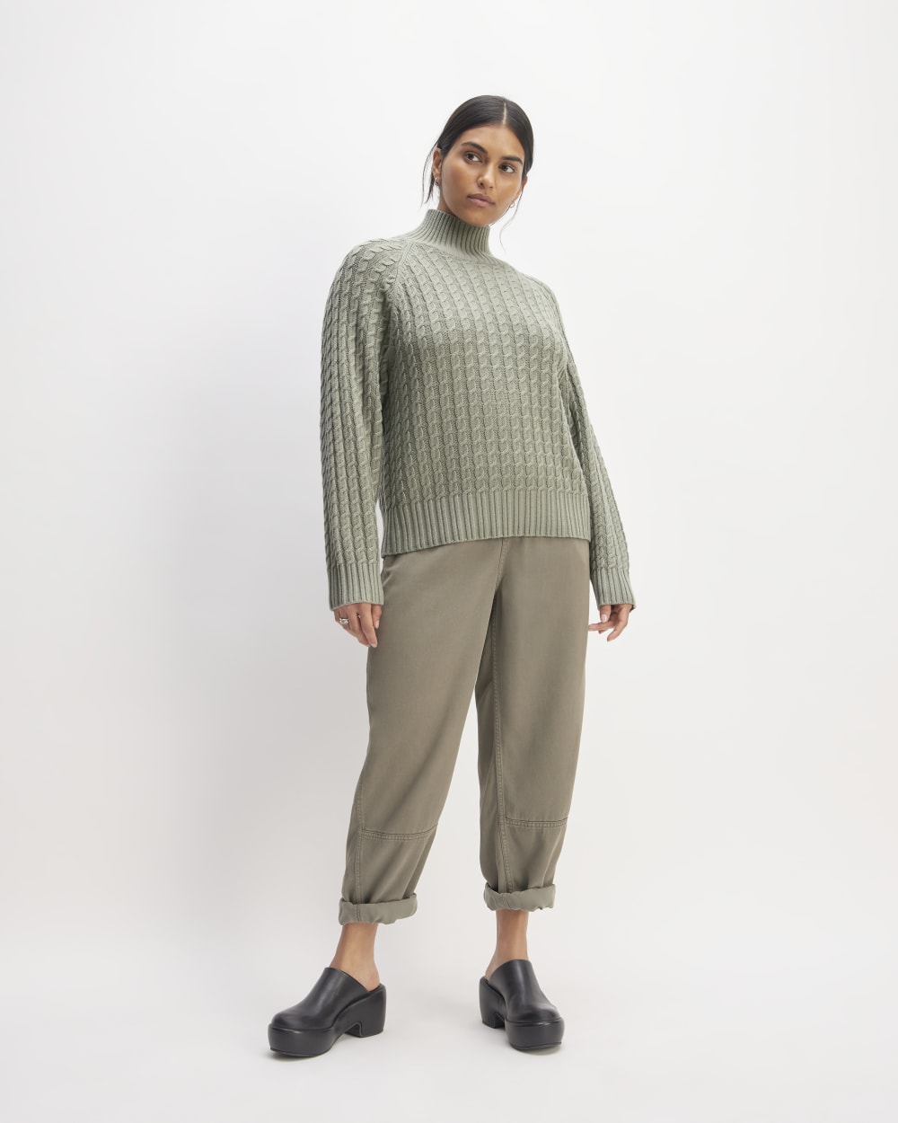 The Cotton Merino Cable Turtleneck in Sage Green — detail view