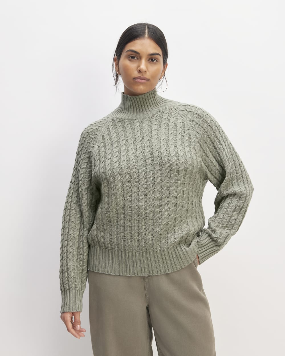 The Cotton Merino Cable Turtleneck in Sage Green — front view