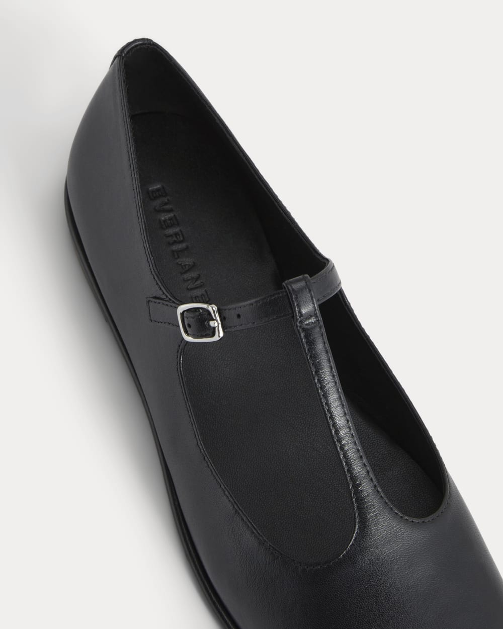 The Leather T-Strap Flat in Black — detail view