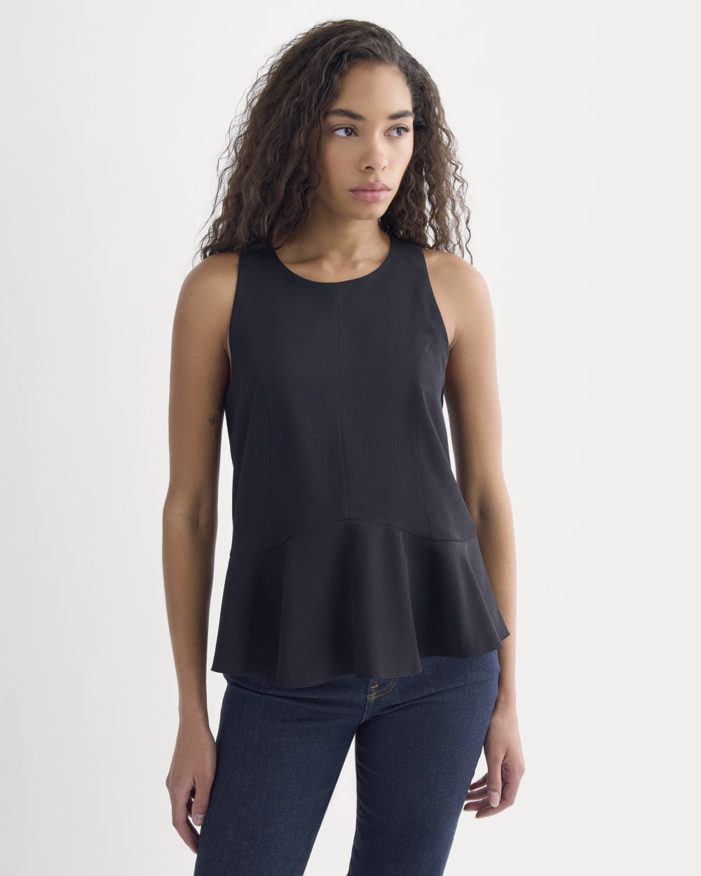 Sleeveless Peplum Top in Black — detail view