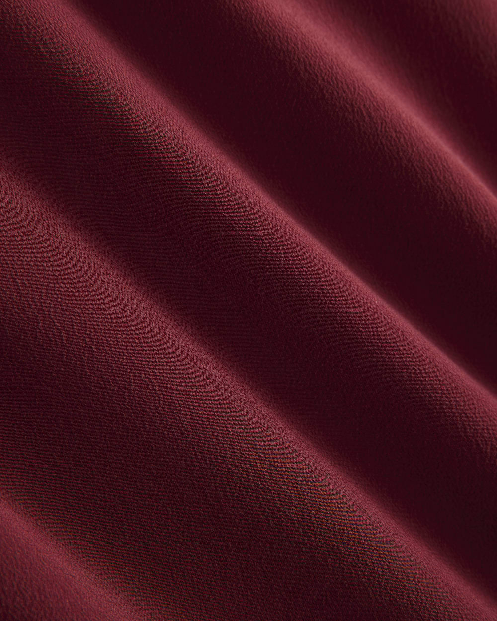 The Boxy Shirt in Washable Silk in Pomegranate — detail view