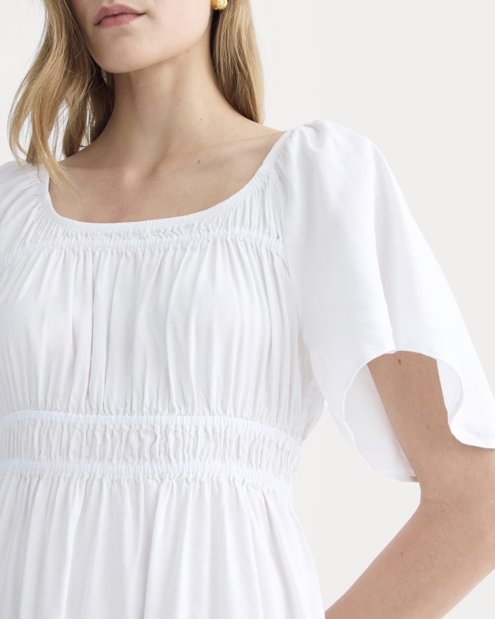 The Flutter-Sleeve Dress in Stretch Linen in White — detail view