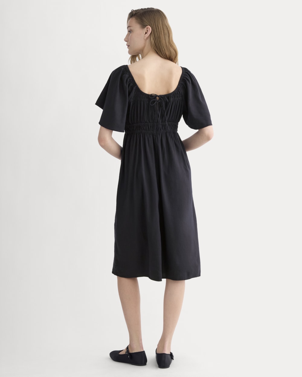 The Flutter-Sleeve Dress in Stretch Linen in Black — detail view