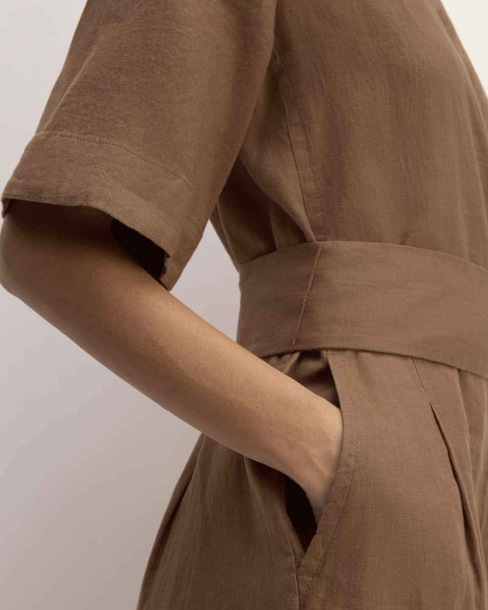 The Wrap Jumpsuit in Linen in Carob Brown — detail view