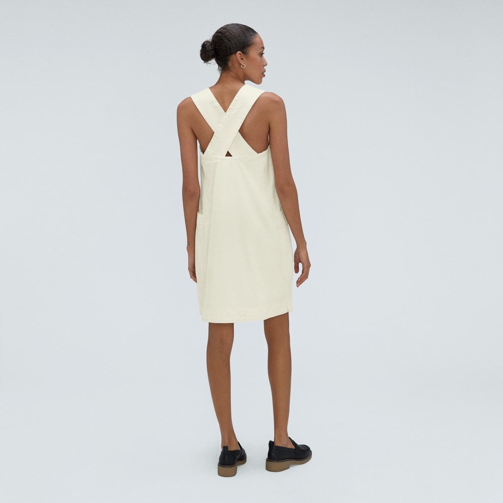 The Cross-Back Apron Mini Dress in Canvas — detail view
