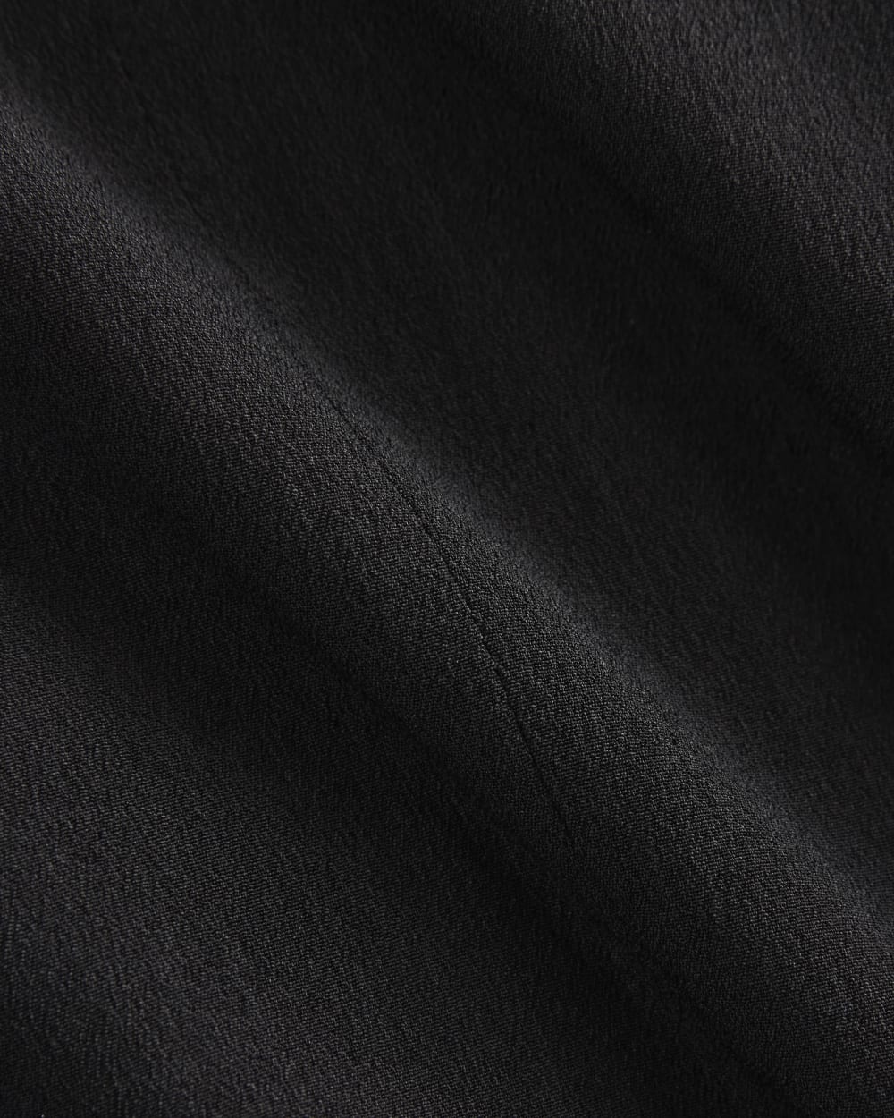 Sleeveless Peplum Top in Black — detail view