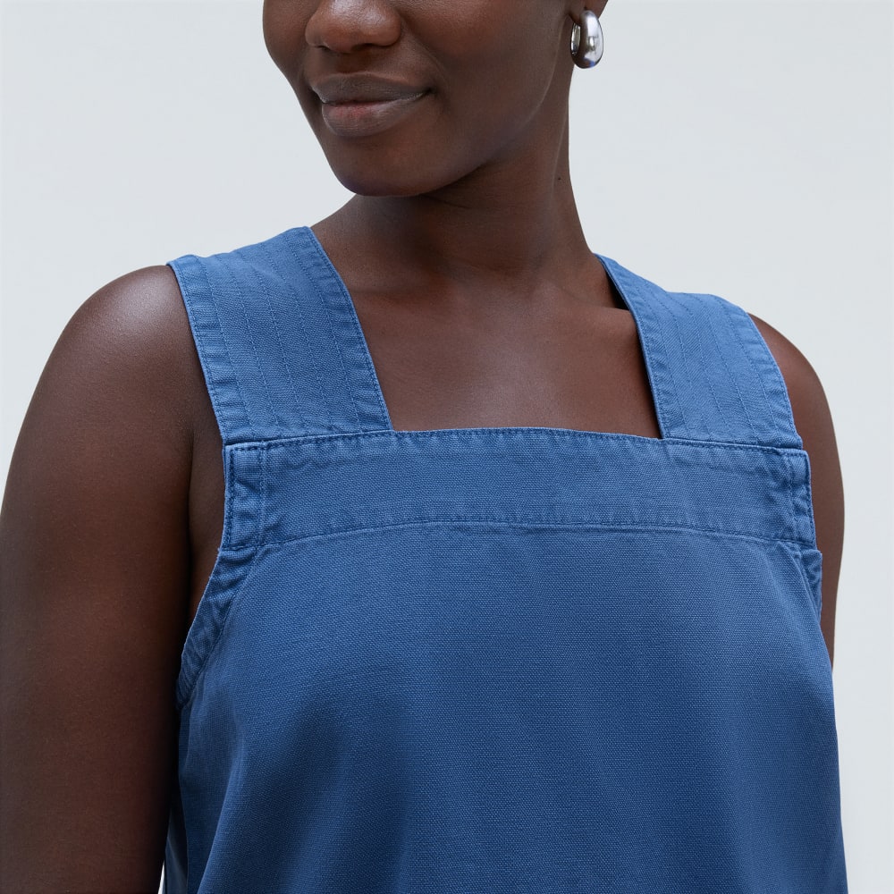 The Cross-Back Apron Mini Dress in Deep Blue — detail view