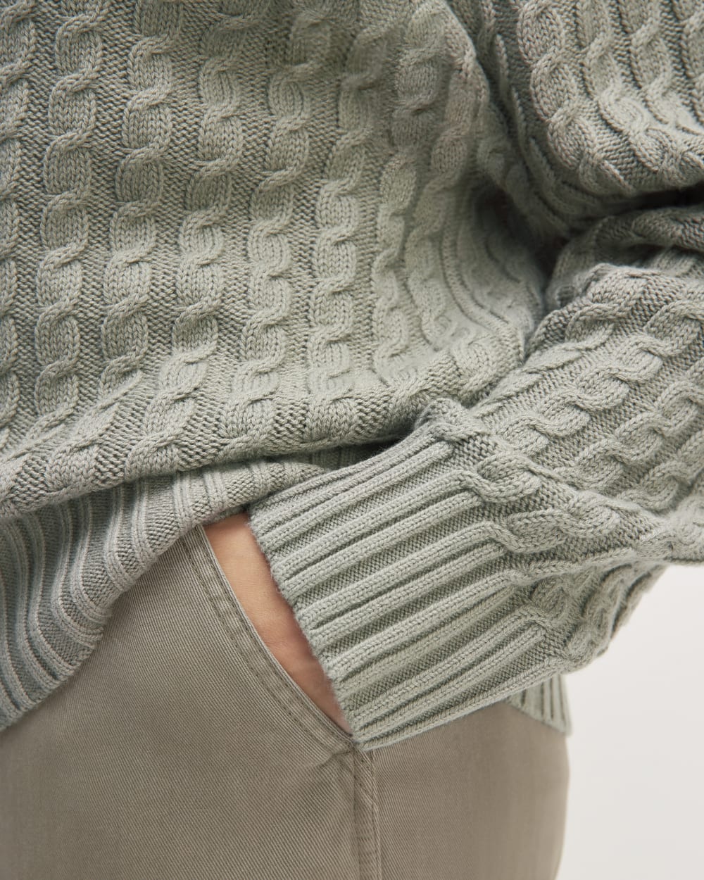 The Cotton Merino Cable Turtleneck in Sage Green — detail view