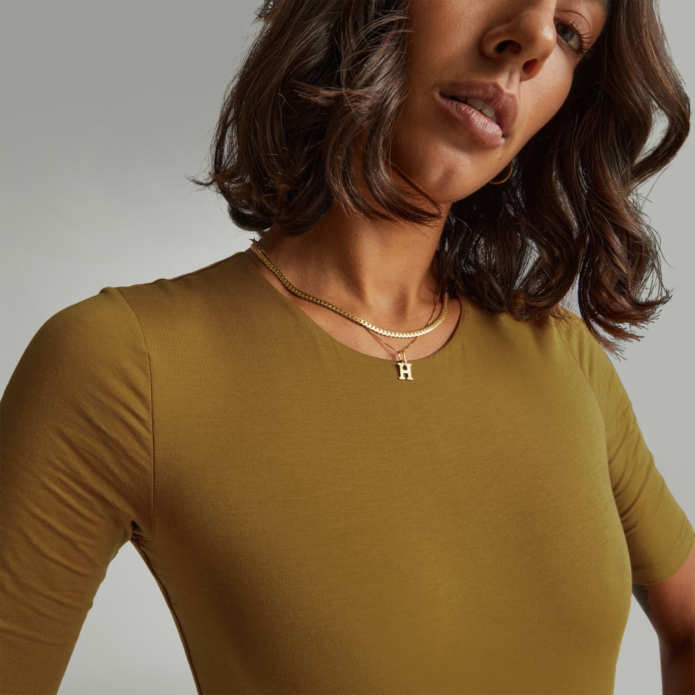 The Short-Sleeve Crew Neck Bodysuit in Tapenade — detail view