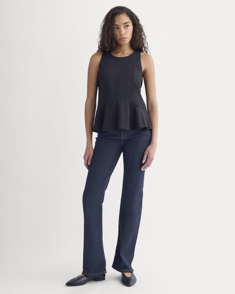 Sleeveless Peplum Top in Black — detail view