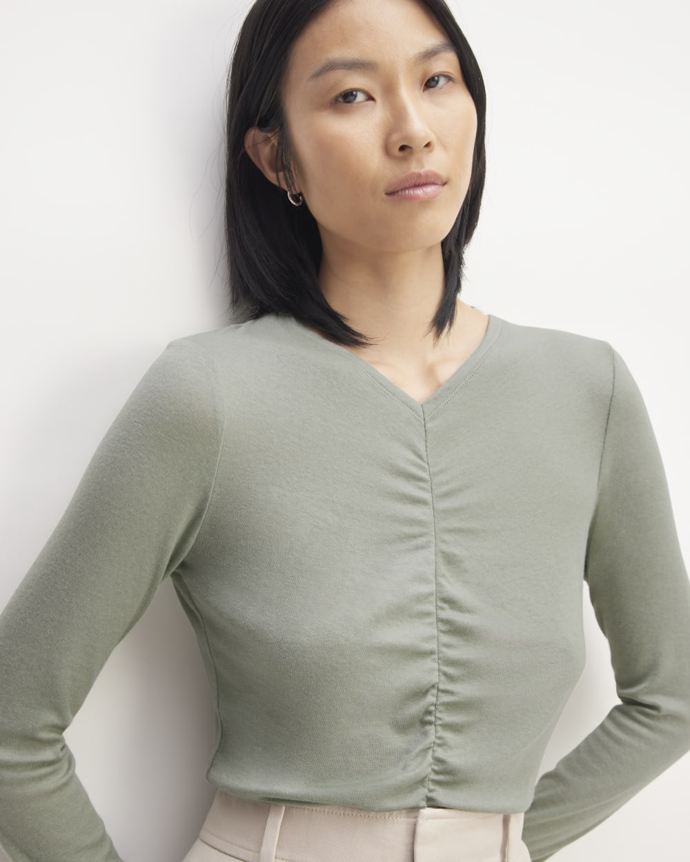 The Ruched V-Neck Tee in Butterluxe in Sage Green — detail view