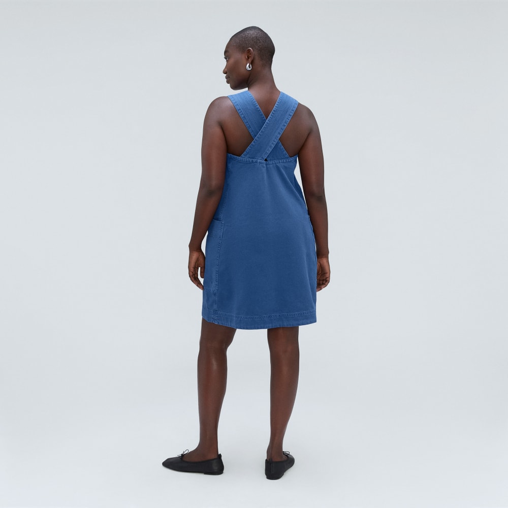 The Cross-Back Apron Mini Dress in Deep Blue — detail view