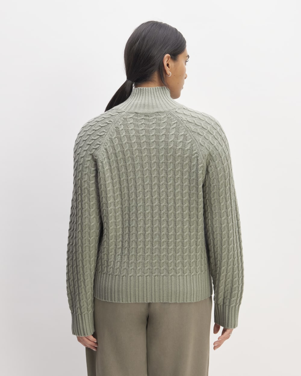 The Cotton Merino Cable Turtleneck in Sage Green — detail view