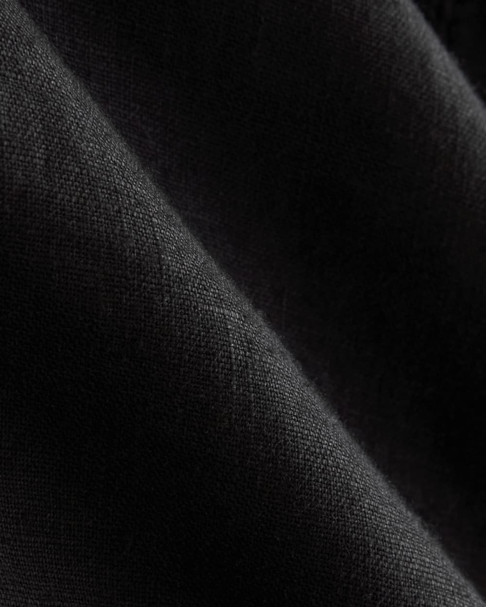 The Linen High-Neck Tank in Black — detail view