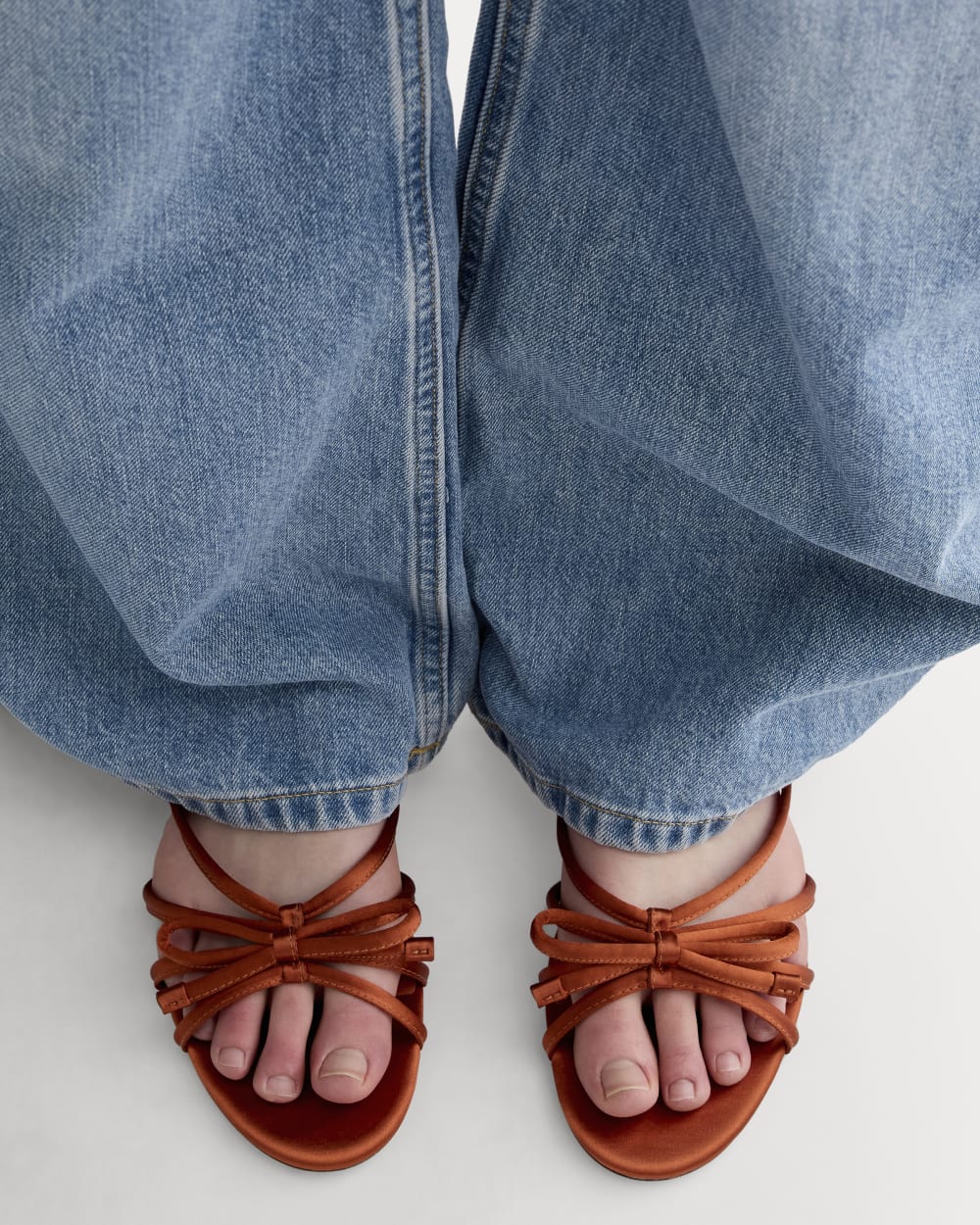The Bow Sandal in Deep Amber Satin — detail view