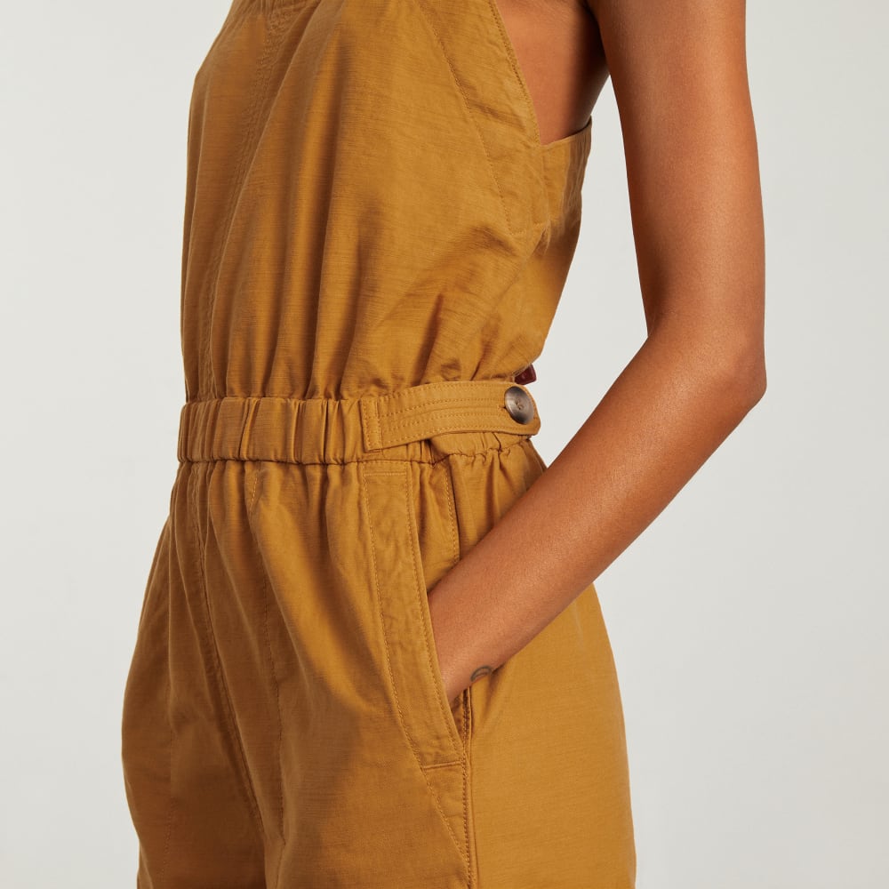 The Fatigue Apron Jumpsuit in Amber — detail view