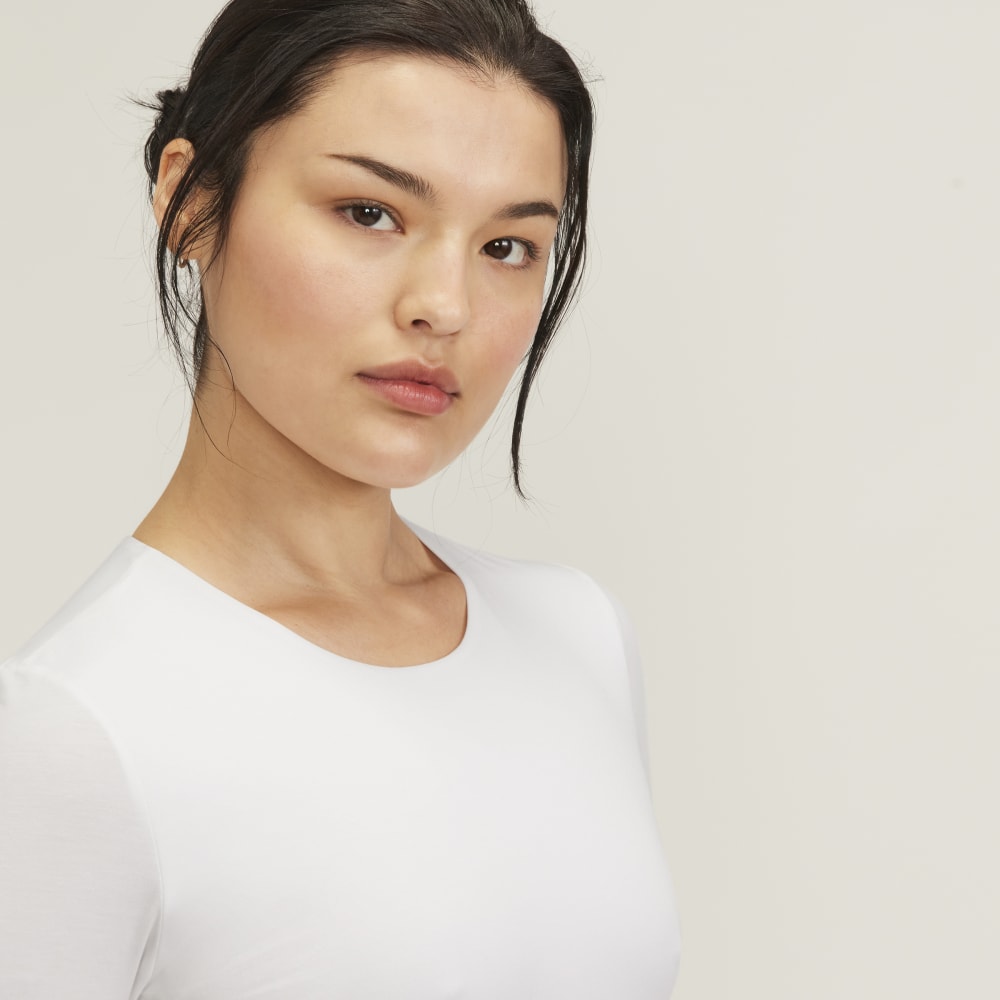 The Short-Sleeve Crew Neck Bodysuit in White — detail view