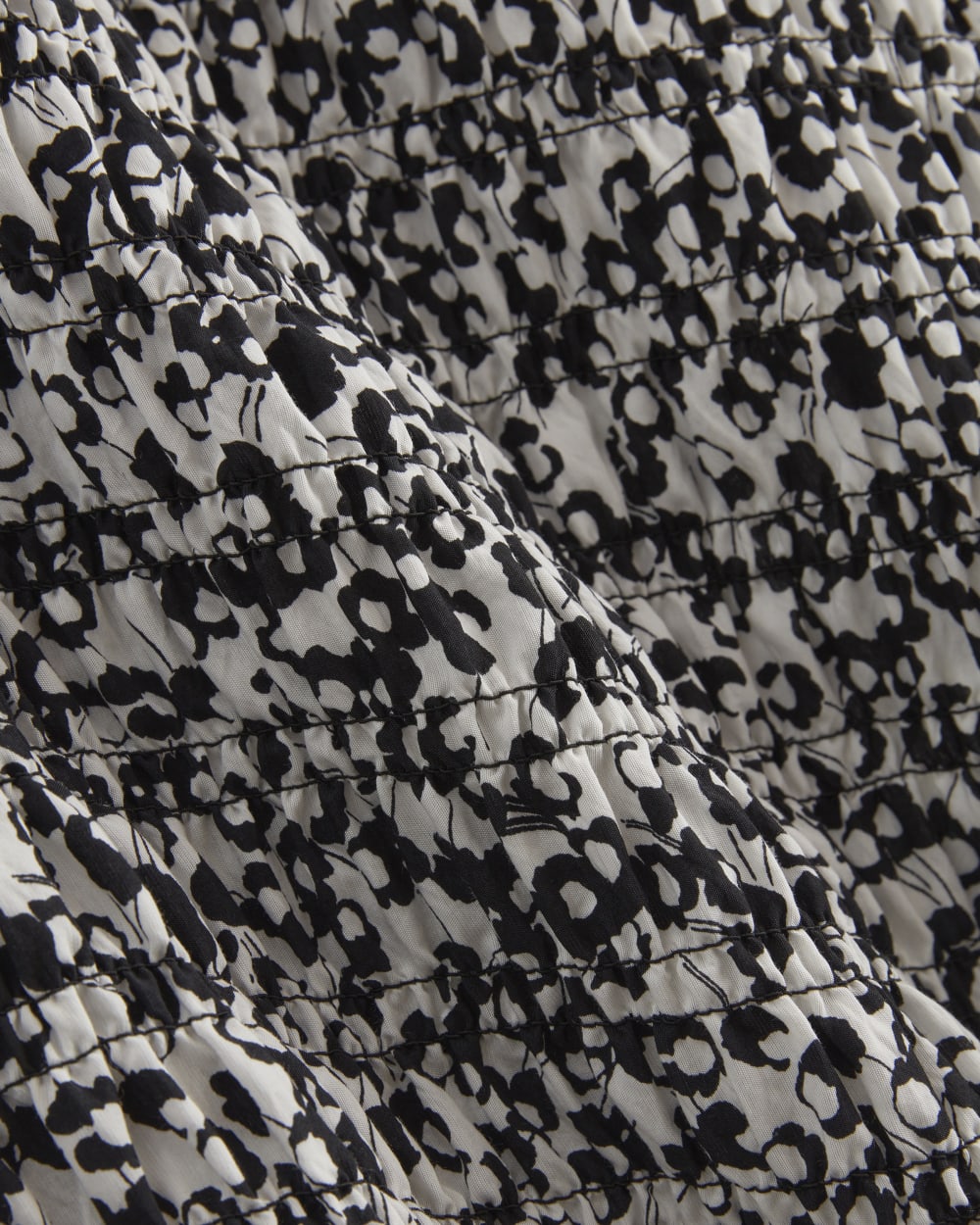 The Smocked Column Dress in Bone / Black Floral — detail view