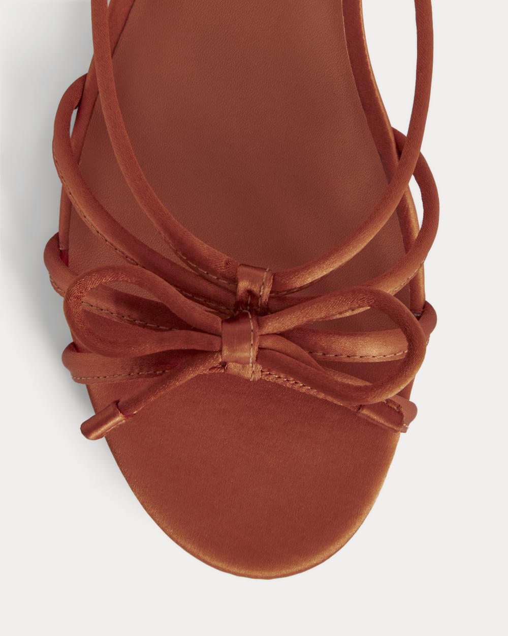 The Bow Sandal in Deep Amber Satin — detail view
