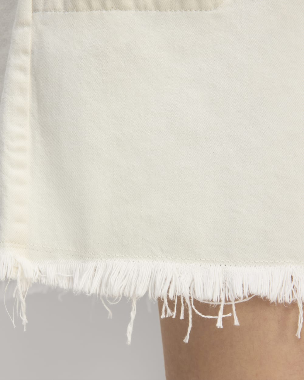 The Denim Workwear Shirtdress in Frayed Hem Bone — detail view