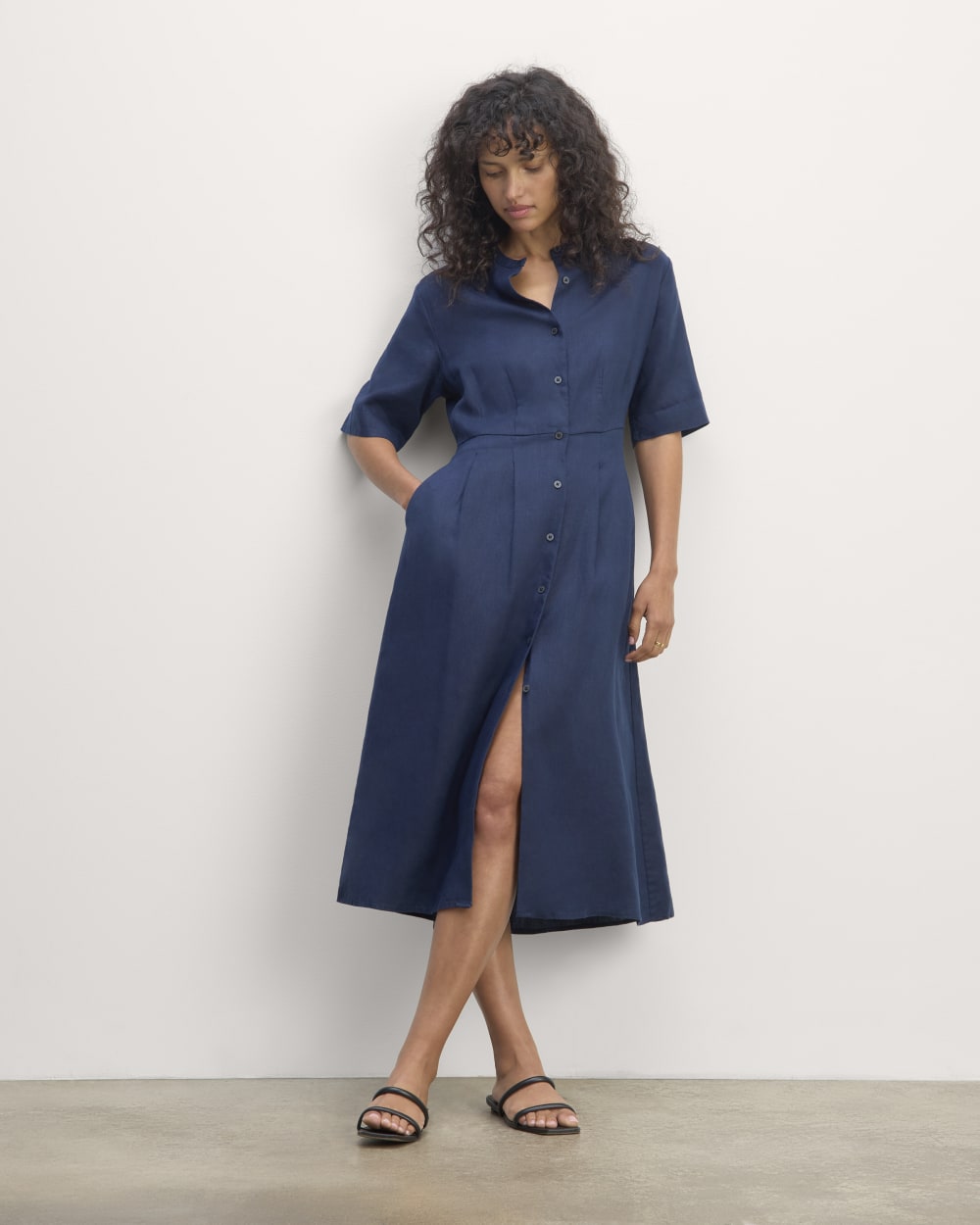 The Frolic Dress in Linen in Navy — front view