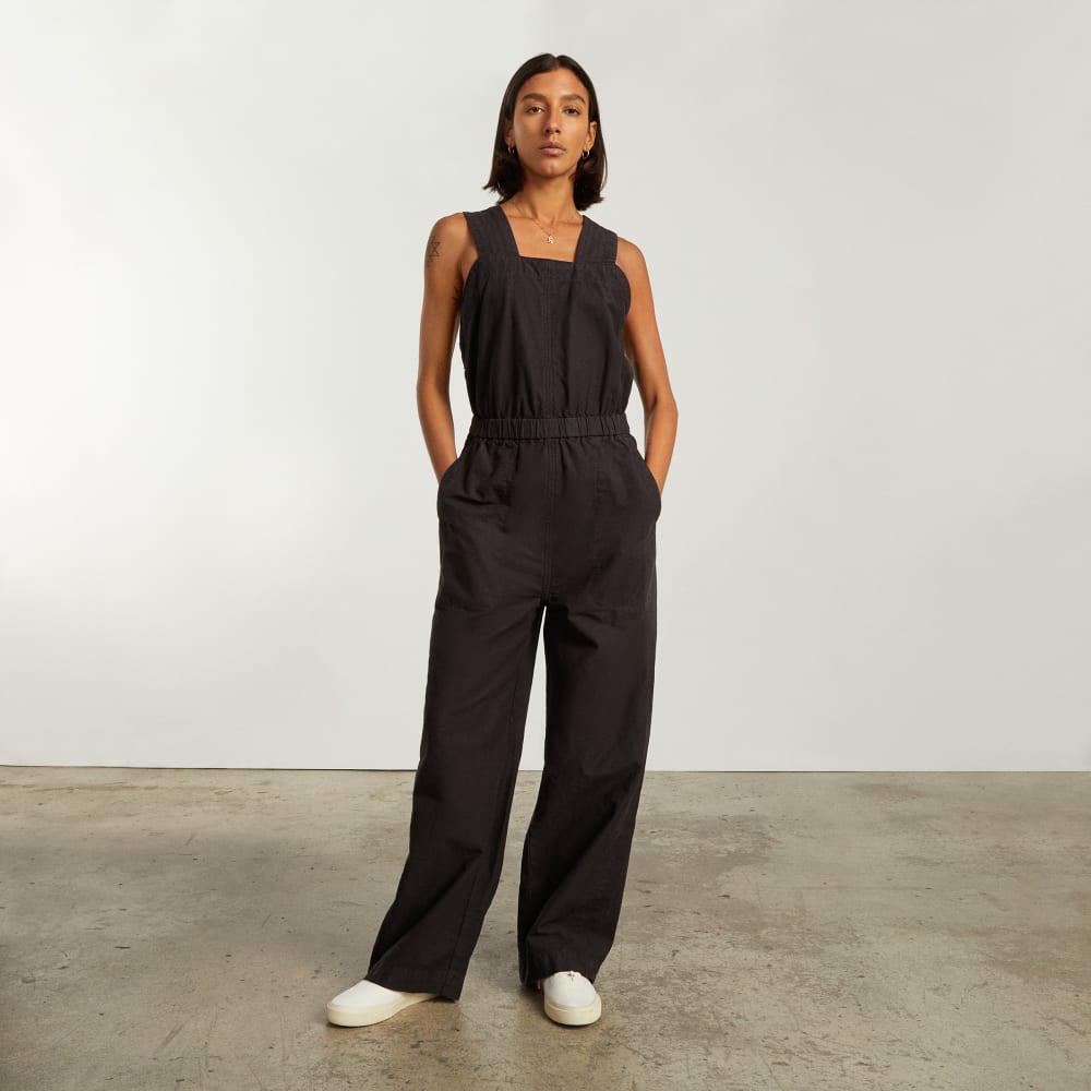 The Fatigue Apron Jumpsuit in Black — front view