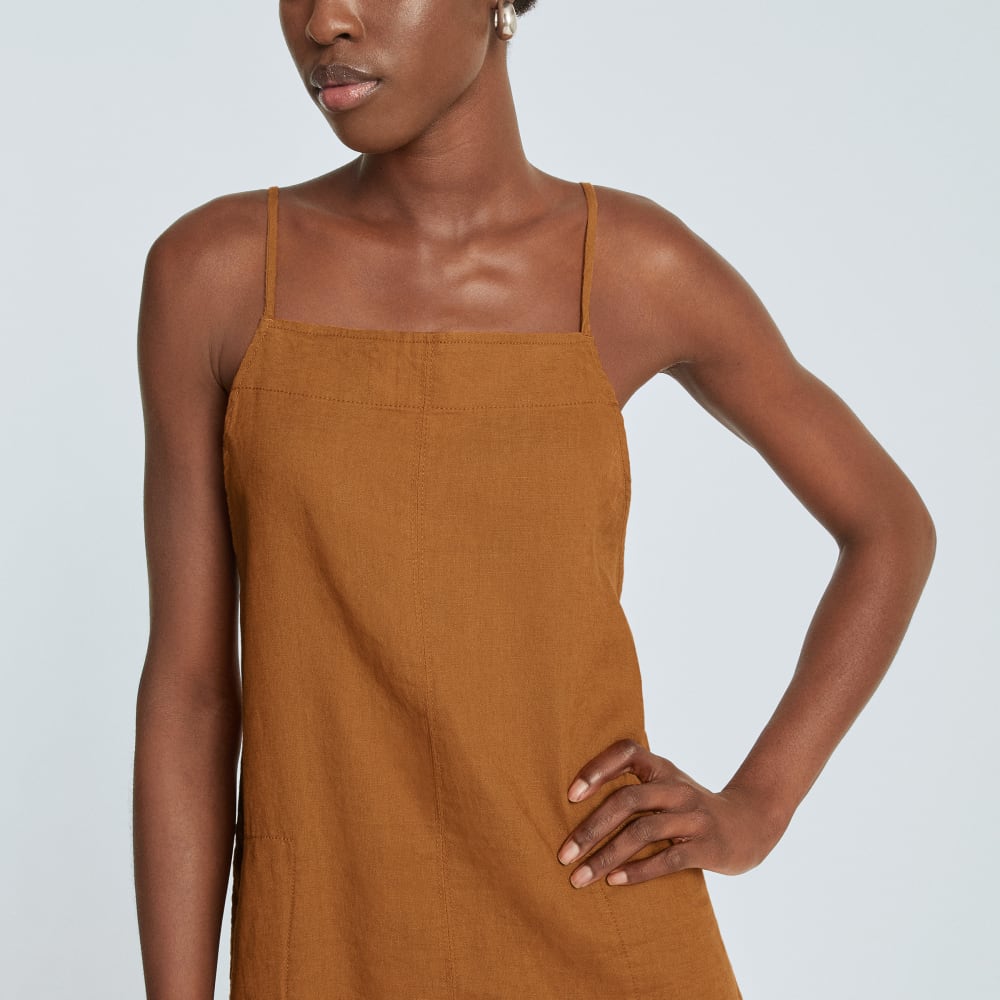 The Linen Apron Dress in Tawny Brown — detail view