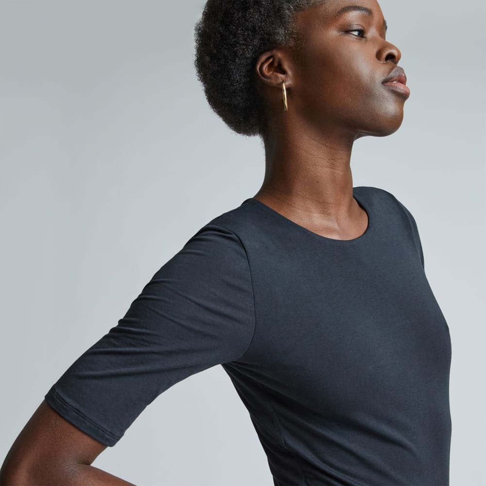The Short-Sleeve Crew Neck Bodysuit in Black — detail view