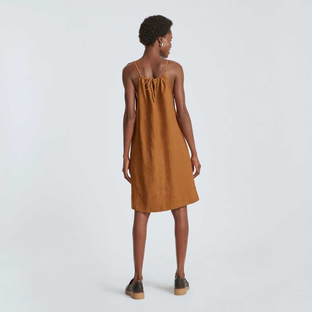 The Linen Apron Dress in Tawny Brown — detail view