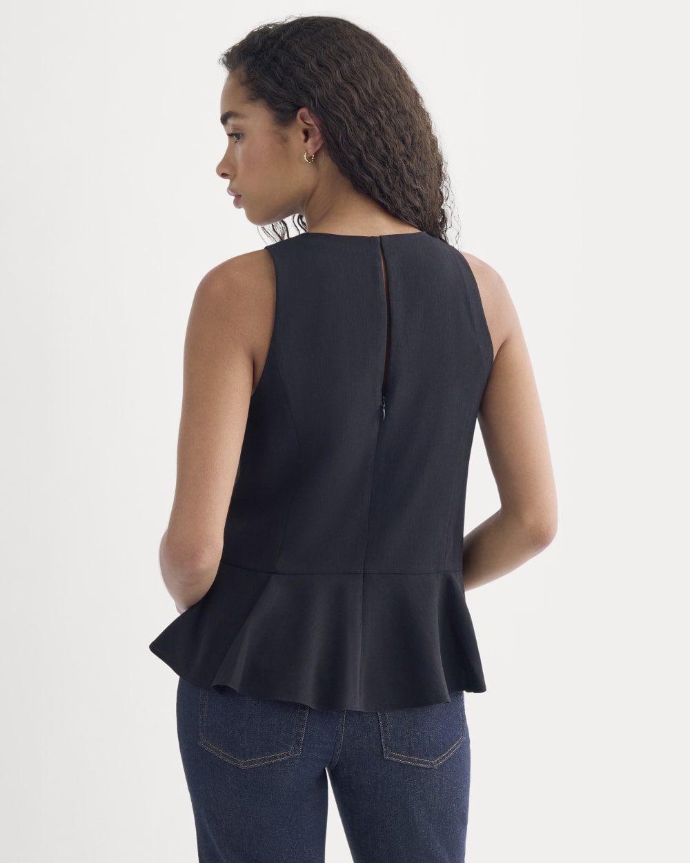 Sleeveless Peplum Top in Black — detail view