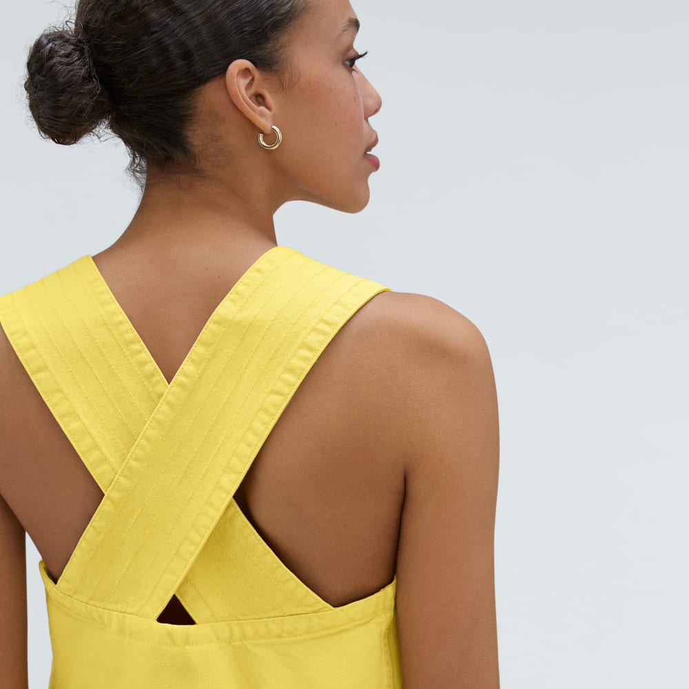 The Cross-Back Apron Mini Dress in Lemon — detail view