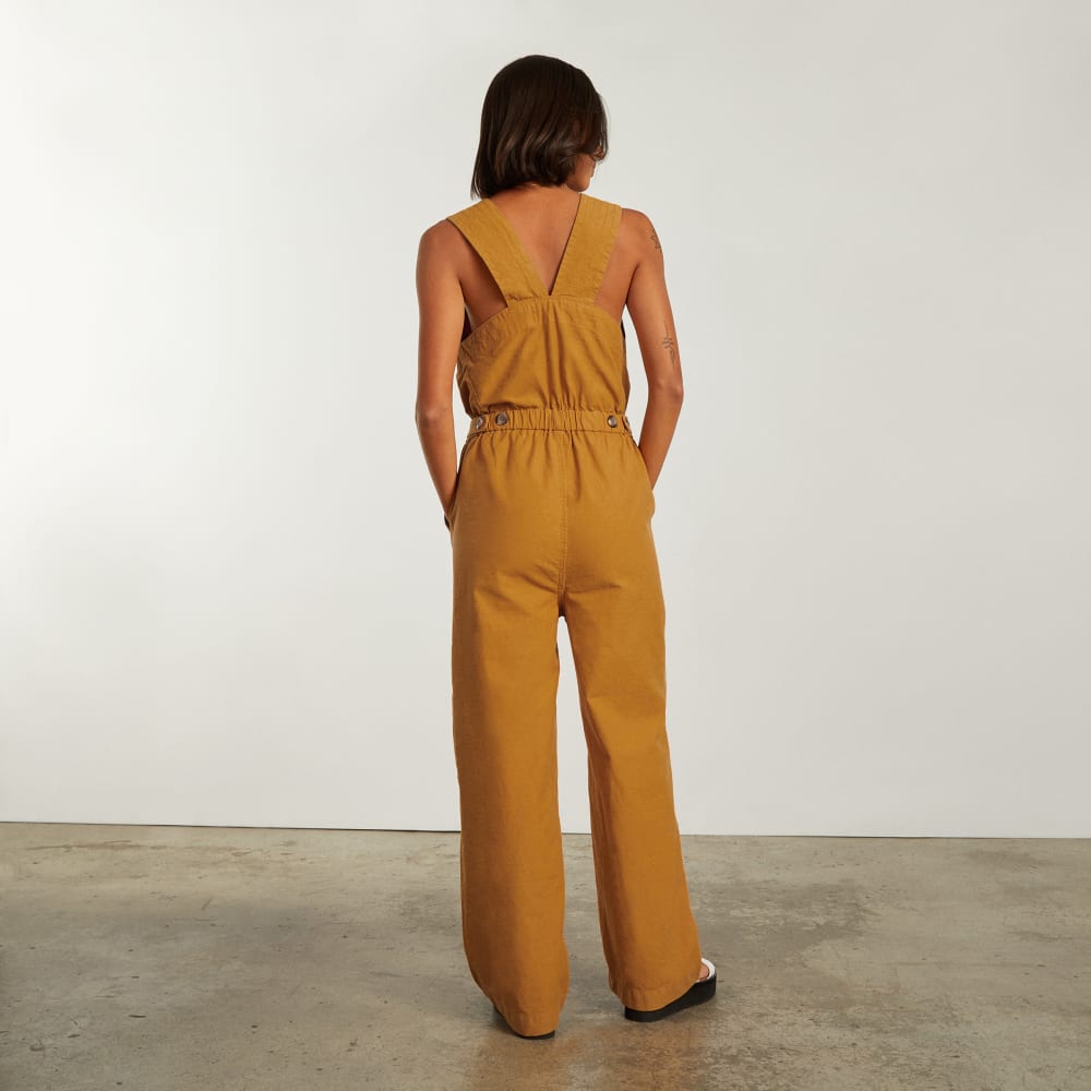The Fatigue Apron Jumpsuit in Amber — detail view