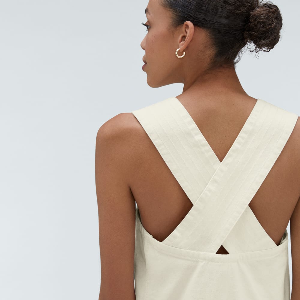 The Cross-Back Apron Mini Dress in Canvas — detail view