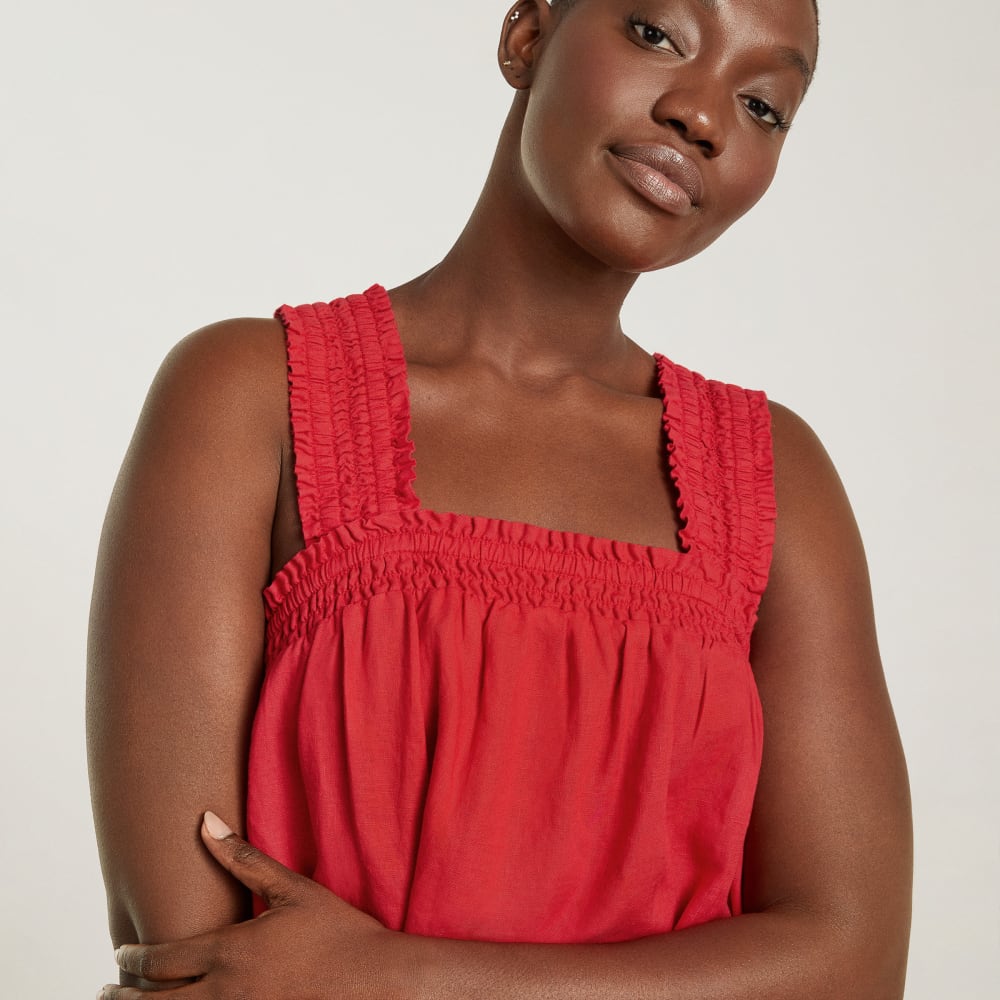 The Smocked Linen Dress in Goji Berry — detail view