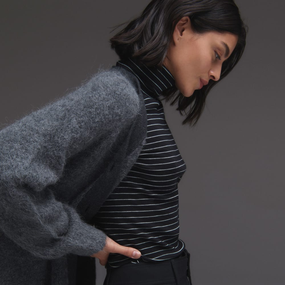 The Luxe Rib Turtleneck in Black / Canvas Tan — detail view