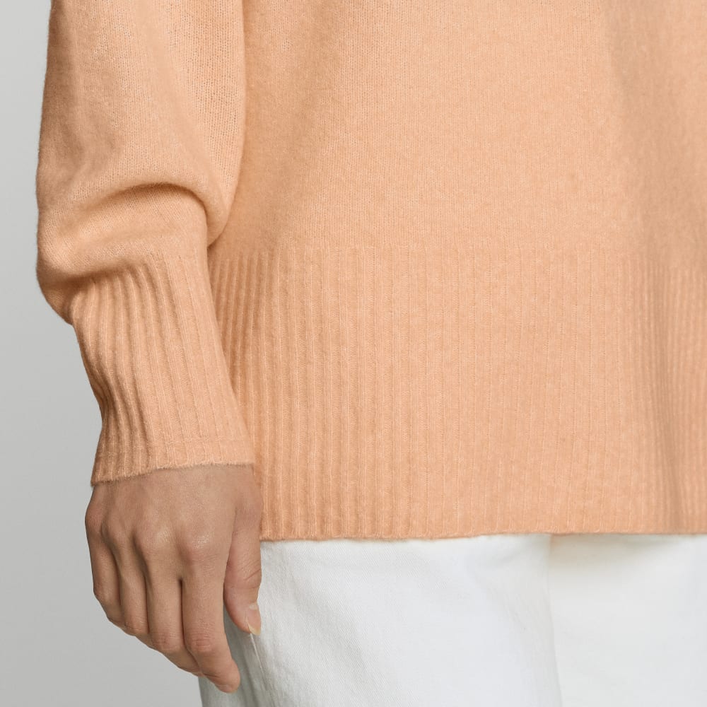 The Cozy-Stretch Pullover in Apricot — detail view