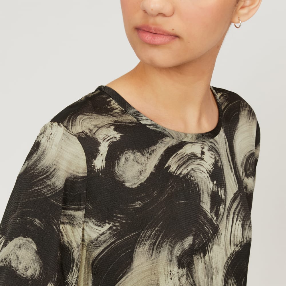 The Satin Relaxed Tee in Pale Yellow / Black — detail view
