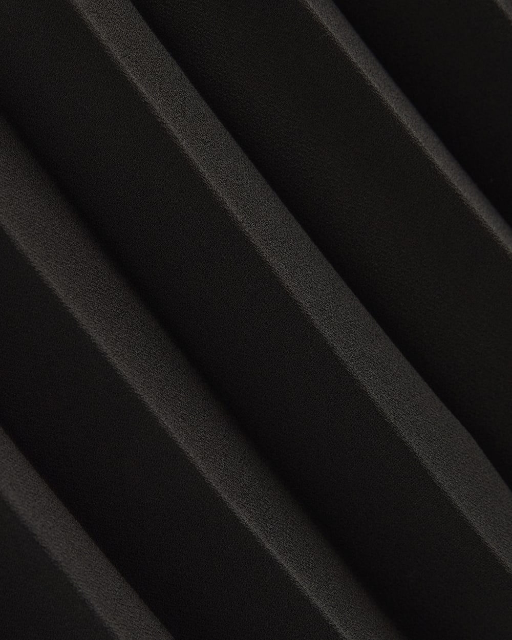 Pleated Crepe Midi Skirt in Black — detail view