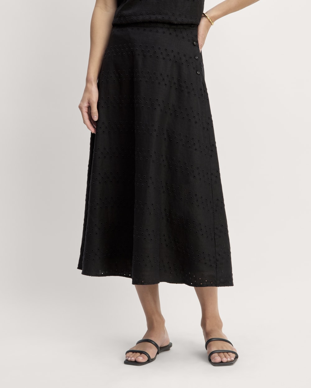 The Linen Eyelet Midi Skirt in Black Eyelet — detail view