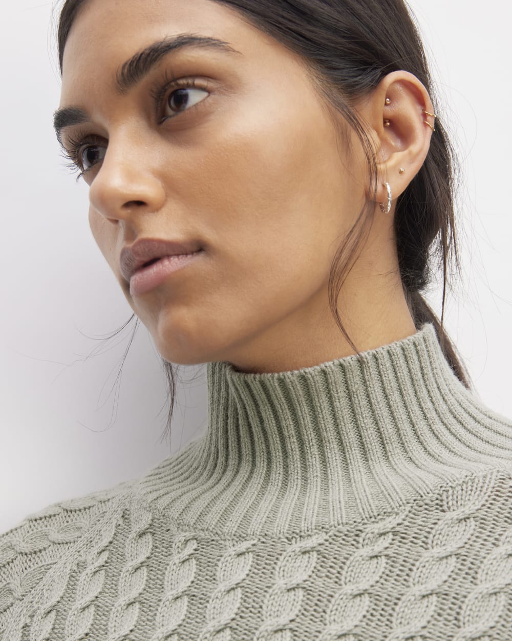 The Cotton Merino Cable Turtleneck in Sage Green — detail view