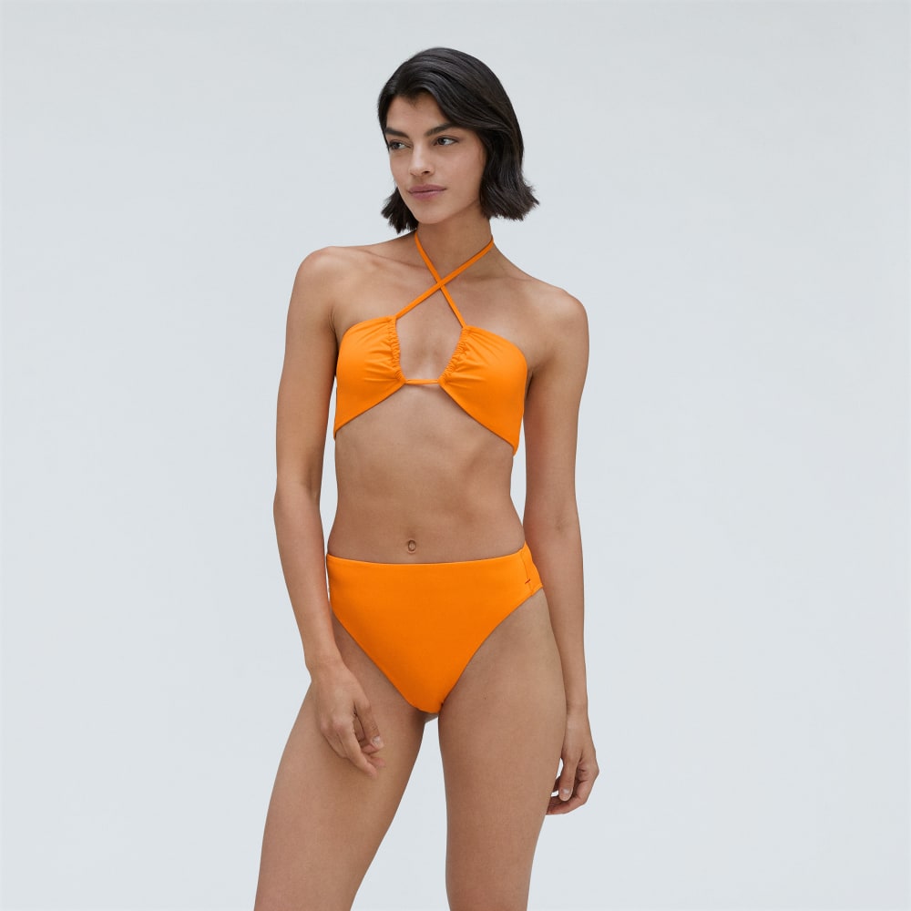The High-Rise Cheeky Bikini Bottom in Turmeric — front view