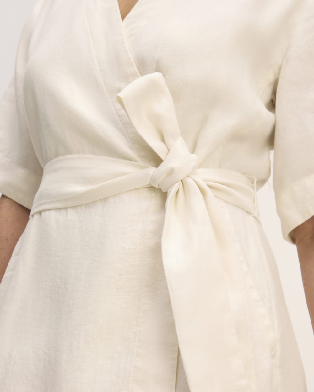 The Wrap Dress in Linen in Bone — detail view
